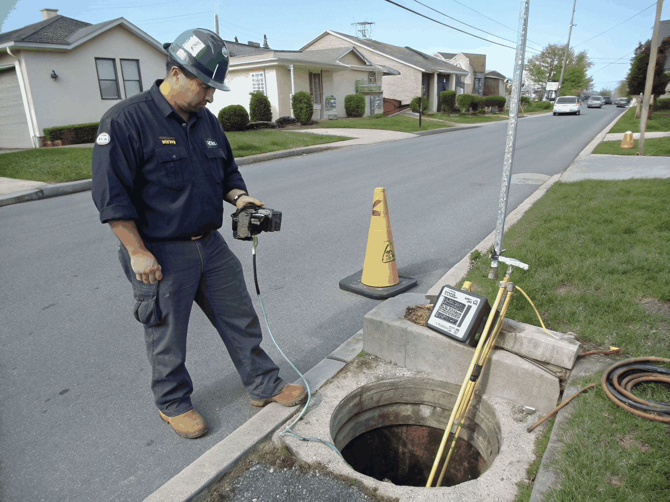 Professional plumbing technician diagnosing and clearing a slow main drain line